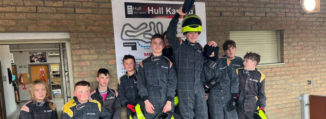 An image of the juniors having their picture taken at the Hull Karting podium