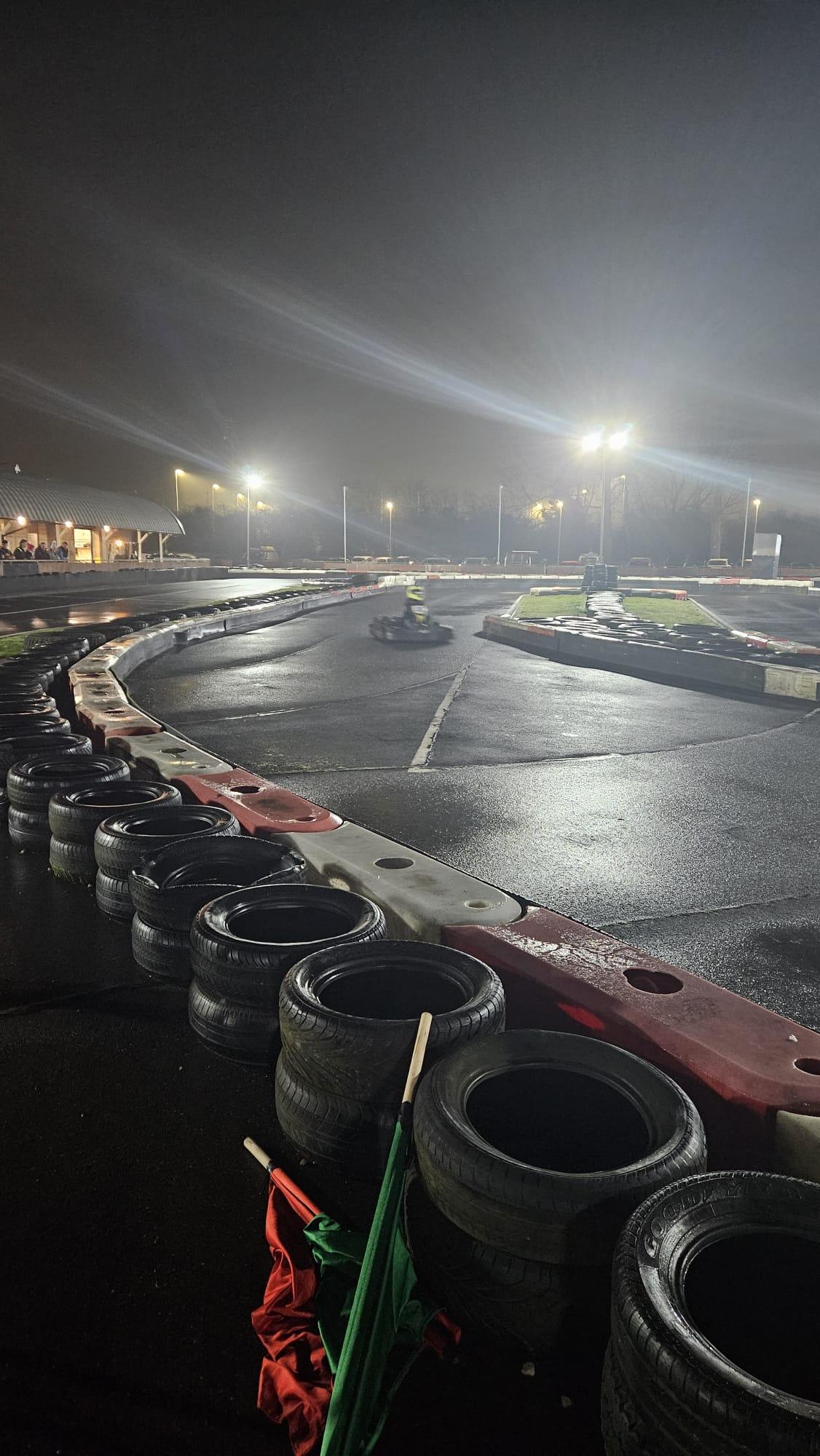 A photograph of a kart racing around the Hull Adventure kart track at night